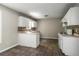 Bright kitchen featuring white cabinets, mosaic backsplash, and tile flooring, freshly renovated at 175 Hearth Way, Fairburn, GA 30213
