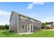 Expansive backyard with a gray-sided home, concrete patio, and plenty of room for outdoor activities at 3366 Bridge Walk Dr, Lawrenceville, GA 30044