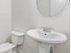Elegant powder room showcasing a pedestal sink and a stylish mirror at 3366 Bridge Walk Dr, Lawrenceville, GA 30044
