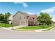 Well-maintained home on a corner lot with green lawn, mature trees, and attached two-car garage at 3366 Bridge Walk Dr, Lawrenceville, GA 30044