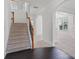 Bright foyer with hardwood floors, staircase, and open archways leading to the living spaces at 3366 Bridge Walk Dr, Lawrenceville, GA 30044