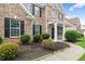 Inviting front porch with brick exterior, well-manicured landscaping, and a welcoming entrance at 3366 Bridge Walk Dr, Lawrenceville, GA 30044