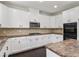 Charming kitchen featuring white cabinetry, stainless steel appliances, and stylish tile backsplash at 3366 Bridge Walk Dr, Lawrenceville, GA 30044