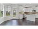 Bright kitchen featuring modern appliances, white cabinets, dark wood floors, and a view to the backyard at 3366 Bridge Walk Dr, Lawrenceville, GA 30044