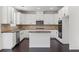 Well-equipped kitchen featuring a central island, sleek stainless steel appliances, and modern white cabinetry at 3366 Bridge Walk Dr, Lawrenceville, GA 30044