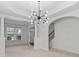 Bright living room with stylish chandelier, arched entryway, and large windows bringing in natural light at 3366 Bridge Walk Dr, Lawrenceville, GA 30044