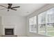 Bright living room boasts a cozy fireplace and large windows, offering abundant natural light and neighborhood views at 3366 Bridge Walk Dr, Lawrenceville, GA 30044