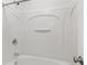 This is a full bathtub with a standup shower behind a white enclosure at 3366 Bridge Walk Dr, Lawrenceville, GA 30044