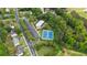 An aerial view of a neighborhood pool and tennis courts surrounded by mature landscaping at 4092 Duran Ln, Auburn, GA 30011