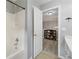 Bright bathroom with white shower/tub, white vanity, and decorative wrought iron at 4092 Duran Ln, Auburn, GA 30011