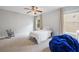This bedroom is bright and features a twin bed, ceiling fan and an accent chair at 4092 Duran Ln, Auburn, GA 30011
