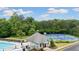 A community pool and tennis courts with clubhouse and chairs in aerial view at 4092 Duran Ln, Auburn, GA 30011