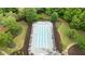 An aerial view of a community pool surrounded by green lawns, chairs, and mature trees at 4092 Duran Ln, Auburn, GA 30011