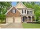 Charming two-story home with a two-car garage, manicured lawn, and inviting front porch at 4092 Duran Ln, Auburn, GA 30011