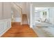 Inviting foyer with hardwood floors, staircase, and a view into the adjacent sitting room at 4092 Duran Ln, Auburn, GA 30011