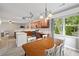 Sunlit kitchen features wood cabinets, stainless appliances and a dining table at 4092 Duran Ln, Auburn, GA 30011