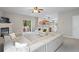 Bright living room featuring fireplace, sliding glass doors, and kitchen access at 4092 Duran Ln, Auburn, GA 30011