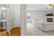 Hallway with bathroom access featuring views of the living room with fireplace at 4092 Duran Ln, Auburn, GA 30011
