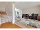 Spacious office area featuring neutral carpet, adjacent sitting room, and a staircase to the second floor at 4092 Duran Ln, Auburn, GA 30011