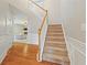 Carpeted stairs with wood trim leading to upper level of the home at 4092 Duran Ln, Auburn, GA 30011