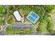 An aerial view of community tennis courts with updated lighting and landscaping at 4092 Duran Ln, Auburn, GA 30011