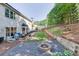 Large backyard with retaining wall, fire pit, and outdoor seating area at 1755 Waters Ferry Dr, Lawrenceville, GA 30043