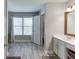 Bright bathroom with plank flooring, large mirror, double sink vanity and a separate shower at 1755 Waters Ferry Dr, Lawrenceville, GA 30043