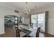Elegant dining room with hardwood floors, modern chandelier, and sightlines into the office at 1755 Waters Ferry Dr, Lawrenceville, GA 30043