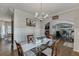 Elegant dining room with hardwood floors, modern chandelier, and sightlines into living spaces at 1755 Waters Ferry Dr, Lawrenceville, GA 30043