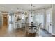 Bright kitchen and dining area with stainless steel appliances, white cabinetry, and a stylish wooden dining table at 1755 Waters Ferry Dr, Lawrenceville, GA 30043
