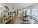 Spacious kitchen and dining area featuring updated cabinetry, stainless appliances, and a charming wooden dining table at 1755 Waters Ferry Dr, Lawrenceville, GA 30043