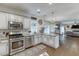 Modern kitchen with stainless appliances, granite countertops, and seamless flow into adjacent living spaces at 1755 Waters Ferry Dr, Lawrenceville, GA 30043