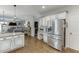 Modern kitchen with granite countertops, stainless steel appliances, and hardwood floors opening up to the living room at 1755 Waters Ferry Dr, Lawrenceville, GA 30043