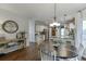 Open-concept kitchen and dining space with a wooden table, stainless appliances, and ample natural light at 1755 Waters Ferry Dr, Lawrenceville, GA 30043