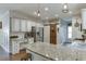 Well-lit kitchen featuring granite countertops, stainless steel appliances, and a stylish breakfast bar at 1755 Waters Ferry Dr, Lawrenceville, GA 30043