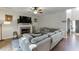 Inviting living room featuring a brick fireplace, flat screen television, and a comfortable gray, sectional sofa at 1755 Waters Ferry Dr, Lawrenceville, GA 30043