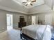 Bright bedroom features neutral walls, tray ceiling, fan, and carpeted flooring at 1755 Waters Ferry Dr, Lawrenceville, GA 30043