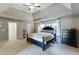 Well-lit bedroom boasts a trey ceiling, plush carpet, and neutral paint at 1755 Waters Ferry Dr, Lawrenceville, GA 30043