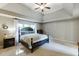 Spacious bedroom features a tray ceiling, neutral walls, and a large window providing ample light at 1755 Waters Ferry Dr, Lawrenceville, GA 30043