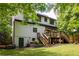 Spacious backyard featuring a wooden deck, stairs, and lush landscaping, perfect for outdoor enjoyment at 2554 Saint Patrick Se St, Atlanta, GA 30317