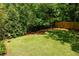 Expansive grassy backyard framed by mature trees and fencing, offering privacy and shade at 2554 Saint Patrick Se St, Atlanta, GA 30317