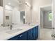 Bright bathroom showcasing dual sinks with marble countertops and a subway tile shower at 2554 Saint Patrick Se St, Atlanta, GA 30317