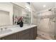 Bathroom featuring double vanity, large mirror, and glass shower at 2554 Saint Patrick Se St, Atlanta, GA 30317