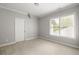 Bright bedroom with neutral carpet and paint and a large window offering natural light at 2554 Saint Patrick Se St, Atlanta, GA 30317