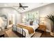 Bright bedroom with hardwood floors, ceiling fan, and ensuite bathroom at 2554 Saint Patrick Se St, Atlanta, GA 30317