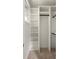 Custom walk-in closet featuring built-in shelving and storage, creating an organized space at 2554 Saint Patrick Se St, Atlanta, GA 30317