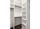 Walk in Closet with custom shelving and dark hardwood floors at 2554 Saint Patrick Se St, Atlanta, GA 30317