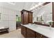 Bathroom vanity with marble countertop, dark wood cabinets, and a view to the outside at 2841 Landing Dr, Marietta, GA 30066