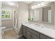 Modern bathroom with gray vanity, white countertop, large mirror, and tub with glass doors at 2841 Landing Dr, Marietta, GA 30066