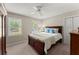 Comfortable bedroom with a wooden bed frame, plush carpeting, and natural light from windows at 2841 Landing Dr, Marietta, GA 30066